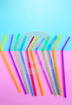 Plastic straws for cocktails. Pastel pink and blue colors. Summer vibes. Hipster party with beverages