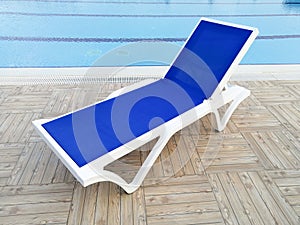 Plastic sunbed close to the swimming pool