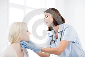 Plastic surgeon or doctor with patient