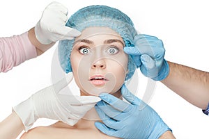 Plastic surgery concept. Doctor hands in gloves touching woman face
