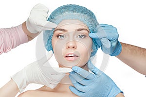 Plastic surgery concept. Doctor hands in gloves touching woman face