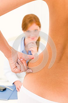 Plastic surgery consultation patient squeeze hips