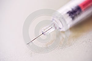 A plastic syringe(disposable syringe) with liquid(fluid), chemical at the laboratory, hospital white.