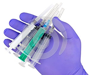 Plastic syringes and needle in hand in medical glove