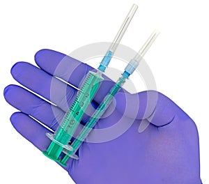 Plastic syringes and needle in hand in medical glove