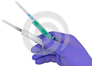 Plastic syringes and needle in hand in medical glove