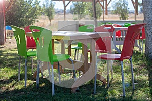 Plastic table and chairs outside in a garden on green lawn