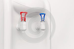 Plastic taps in water office cooler. Cold and hot water