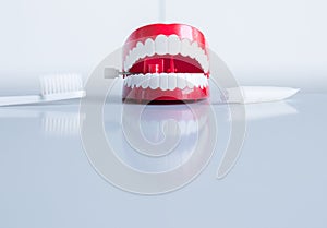 Plastic teeth models with toothbrush and toothpaste