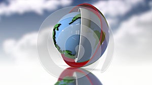 Plastic terrestrial globe rotating between two hemispheres on cloud background
