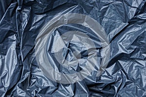 Plastic texture of black cellophane on a crumpled bag