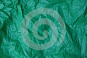 Plastic texture of a piece of crumpled green cellophane