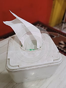 Plastic Tissue Box on White Table with Red Background