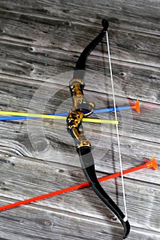 A plastic toy of a bow and arrows, Archery, The bow and arrow is a ranged weapon system consisting of an elastic launching device
