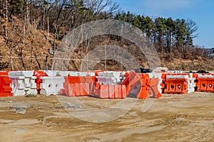 Plastic traffic barriers sitting at new construction site