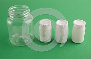 Plastic transparent bank and three white banks with lids