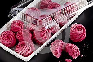 Plastic transparent container with homemade currant marshmallow.