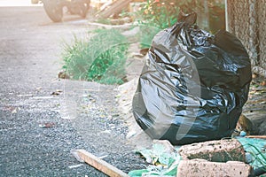 Plastic trash bag. Pile black garbage roadside