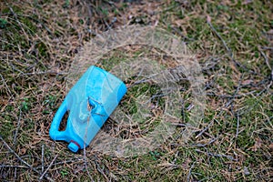 Plastic trash in the forest. Tucked nature. Plastic container lying in the grass.