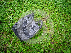 Plastic trash on green grass. photo