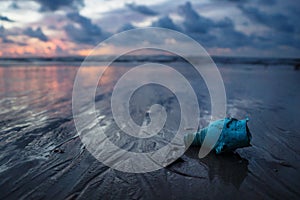 Plastic trash littering the ocean at the beach during sunset, Koh Lanta, Thailand