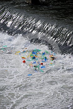 Plastic trash trapped at waterfall