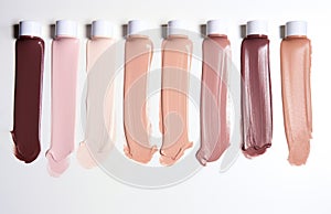 Plastic tubes with multicolored texture. Swatch cosmetic lip gloss. Liquid texture lipstick isolated on white background