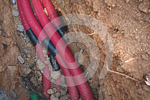 Plastic tubing for use as electrical conduit in a hole dug in the ground.