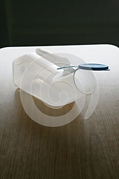 Plastic urinal on a table photo