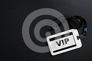 Plastic vip badge on black background, top view. Space for text