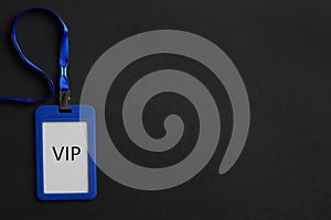 Plastic vip badge on black background, top view. Space for text