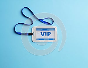 Plastic vip badge on light blue background, top view