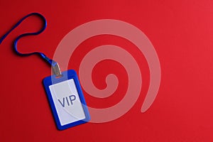 Plastic vip badge on red background, top view. Space for text