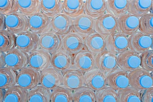 Plastic water bottle background, blue bottle caps, orderly arrangement