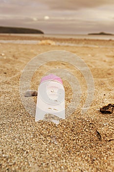 Plastic water bottle left discarded on a beach in Wales. Plastic waste in our oceans photo