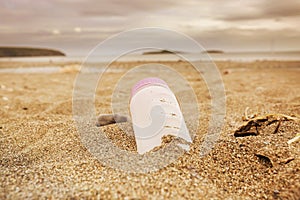 Plastic water bottle left discarded on a beach in Wales. Plastic waste in our oceans photo