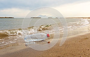 Plastic water bottle washed up on a sandy beach