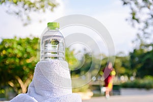 Plastic water bottle and white cloth on desk with running exerci