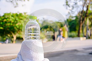 Plastic water bottle and white cloth on desk with running exercise people