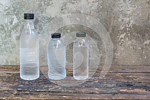 plastic water bottles on the old wooden table background