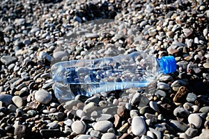 Plastic water bottles pollution in sea beach, dirty coast, beach pollution