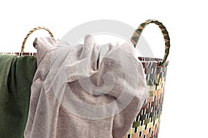 Plastic weaved laundry basket with T-shirt  on white background.