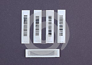 Plastic White Barcode Soft Tags on gray background.