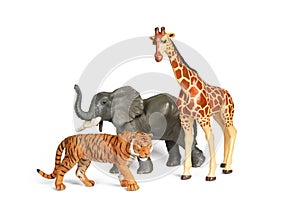 Plastic wild african animal toys isolated on white. Tiger, Elephant and giraffe. Children animal characters for playing zoo game