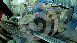 Plastic windows. Worker Cutting PVC Profile with Circular Saw.PVC windows and doors manufacturing.