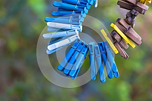 Plastic, wood, old clothes pegs hanging on a rope