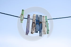 Plastic and wooden clothes pins on a rope, close up, macro photography
