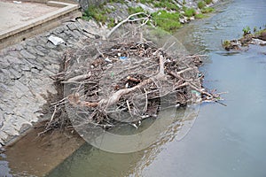 Plastic and wooden garbage in the river , pollution and environment concept