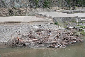 Plastic and wooden garbage in the river , pollution and environment concept