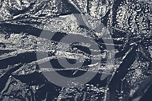 Plastic wrap texture for overlay. wrinkled stretched plastic effect. transparent plastic wrap on black background